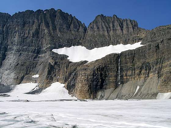 Waterfall emanating from Salamander Glacier tumbling down a cliff and into Upper Grinnell Lake